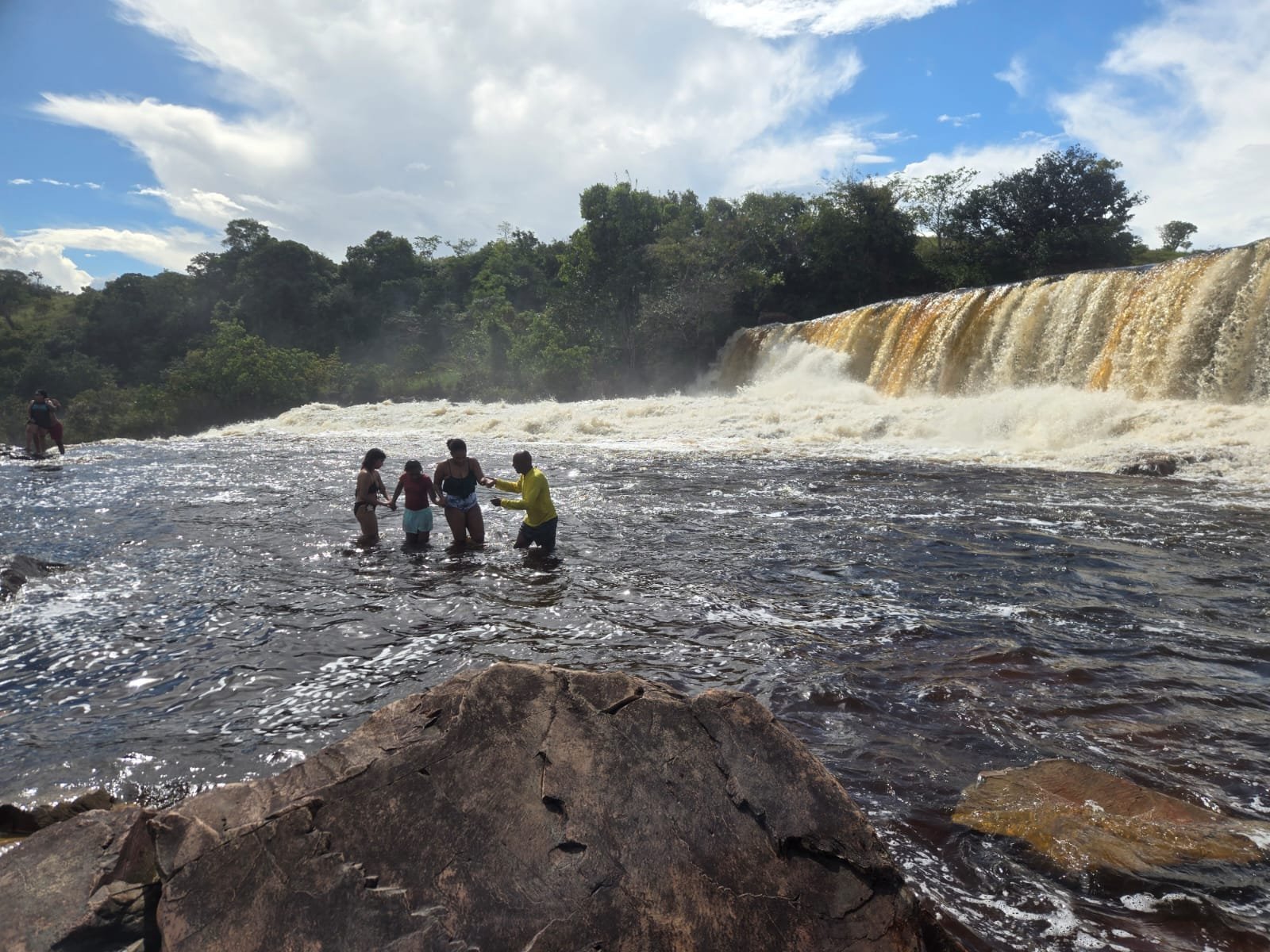 Orinduik Falls landscape with swimmers enjoying natural pools